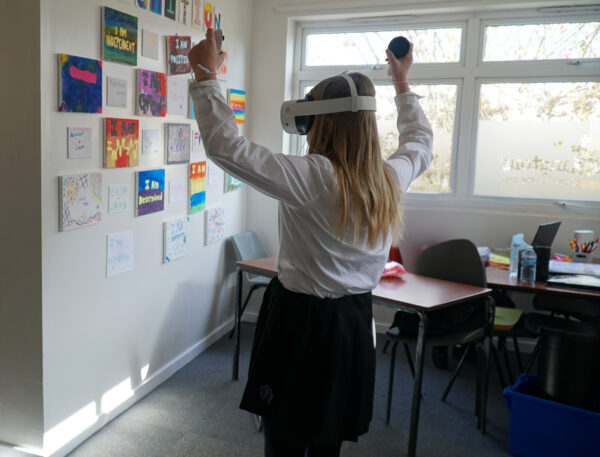 Student celebrating whilst using virtual reality